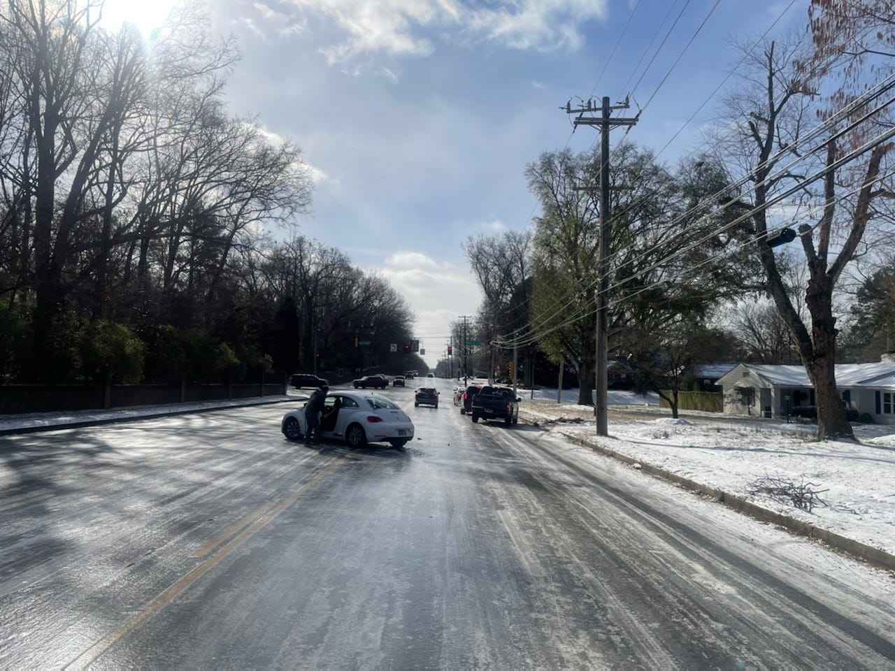 Cars slide across an ice-covered White Station Road in Memphis on Dec. 23. Memphis roads were coated in snow and ice after a cold front dropped temperatures into single digits.