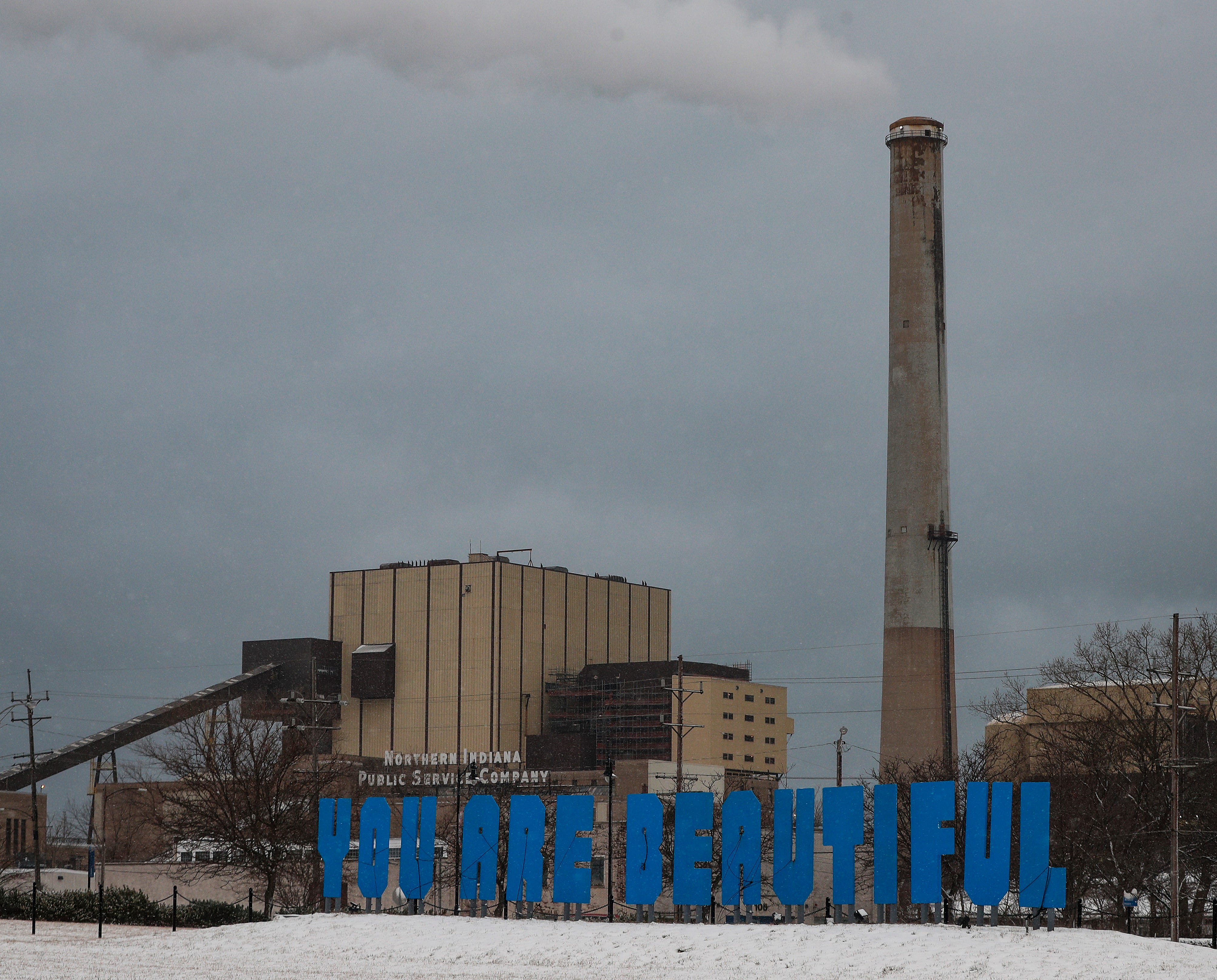 A sign reads "You are beautiful,' in a park next in front of the NIPSCO Michigan City plant on Tuesday, Jan. 27, 2021 in downtown Michigan City, Ind.