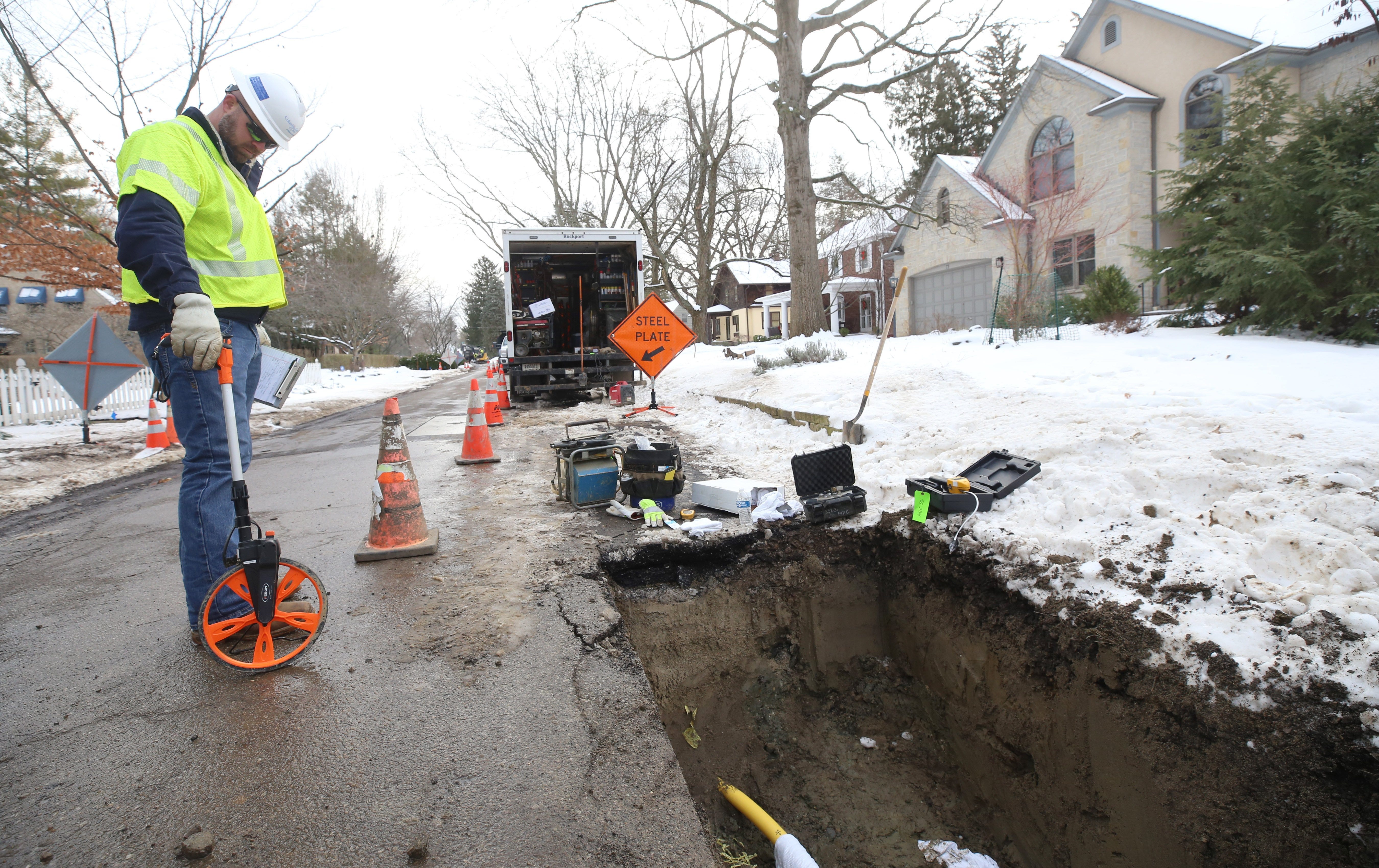 Mark Chronaberry, construction coordinator for Columbia Gas of Ohio, takes some measurements on Royal Forest Boulevard on Jan. 19 where crews are installing new lines. The gas company is one of many utilities across Columbus raising rates on consumers this year.