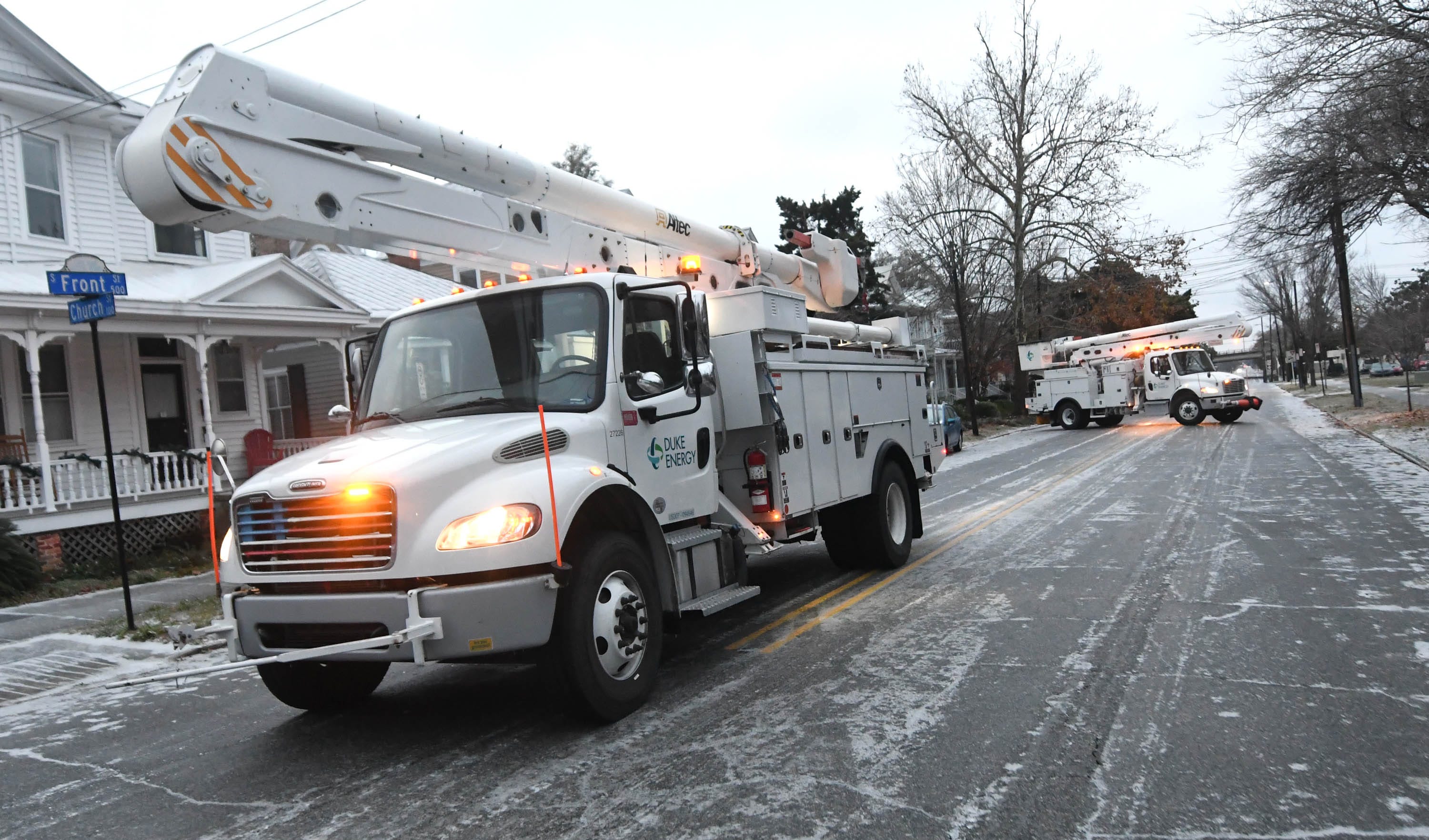 Crews with Duke Energy fix a power outage due to ice on Church St. in downtown Wilmington, N.C., Saturday Jan. 22, 2022. A wintry mix fell throughout the night over the Wilmington area and created dangerous conditions. [MATT BORN/STARNEWS]
